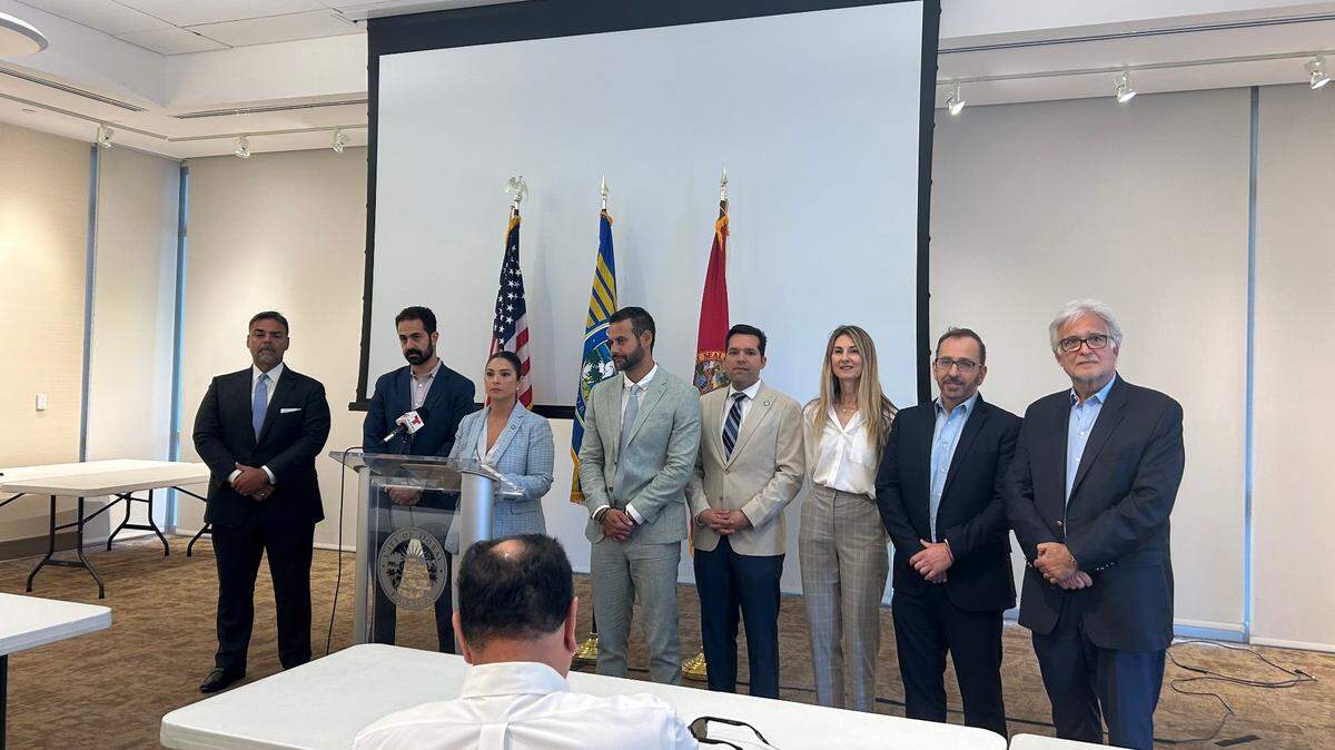 Doral Mayor Christi Fraga stands with Josh Sayles of the Greater Miami Jewish Federation (left) and Miami Beach Commissioner David Suarez (right), to rescind an earlier resolution calling for peace in the Middle East and an end to all “hostilities” after facing backlash from the Jewish community.