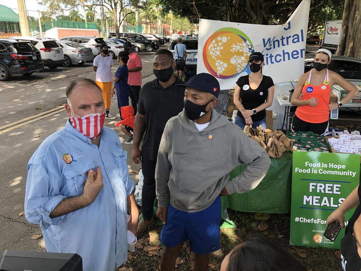 Chef José Andrés, left, and singer Pharrell Williams talks to reporters outside the Coral Gables early-vote site on Saturday, Oct. 31, 2020 (Photo by Douglas Hanks, Miami Herald)
