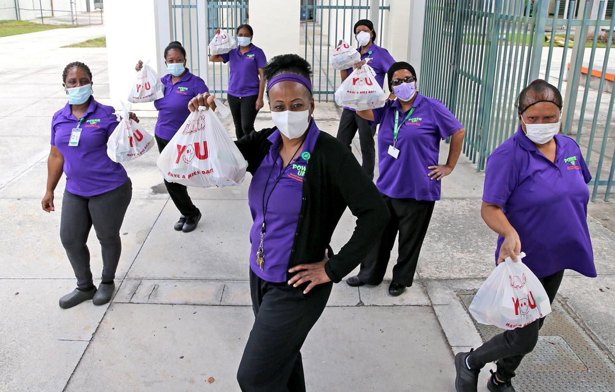 Sonia Stroman, (C) cafeteria manager at McArthur High School, poses with co-workers.