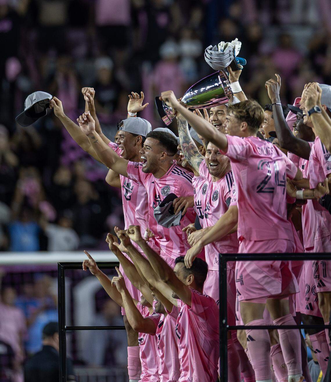 Inter Miami forward Lionel Messi (10) holds the Eastern Conference final trophy on stage as he celebrates with teammates after a 5-1 win over New York City FC in the MLS Eastern Conference final at Chase Stadium on Saturday, Nov. 29, 2025, in Fort Lauderdale, Fla. The victory sends Inter Miami to its first MLS Cup final.