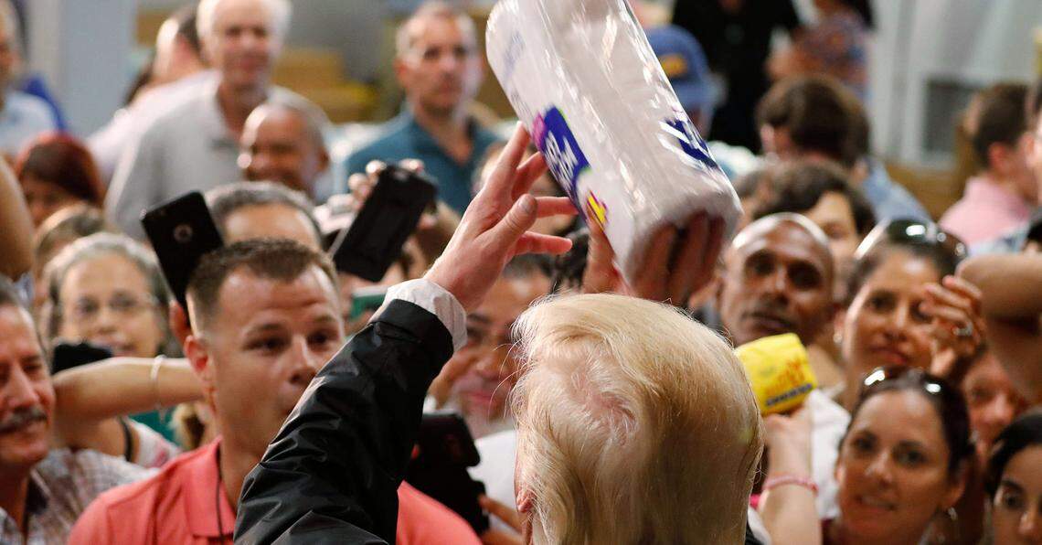 U.S. President Donald Trump throws rolls of paper towels to a crowd of local residents affected by Hurricane Maria as he visits a disaster relief distribution center at Calgary Chapel in San Juan, Puerto Rico, U.S., October 3, 2017.