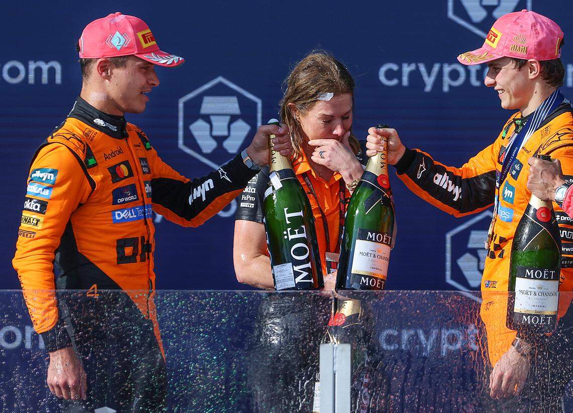 McLaren driver Lando Norris of Britain, left, and McLaren driver Oscar Piastri of Australia, right toast as Louise McEwen, chief marketing office, stands drench in champagne during the trophy ceremony at the Formula One Miami Grand Prix at the Miami International Autodrome on Sunday, May 4, 2025, in Miami Gardens, Fla.