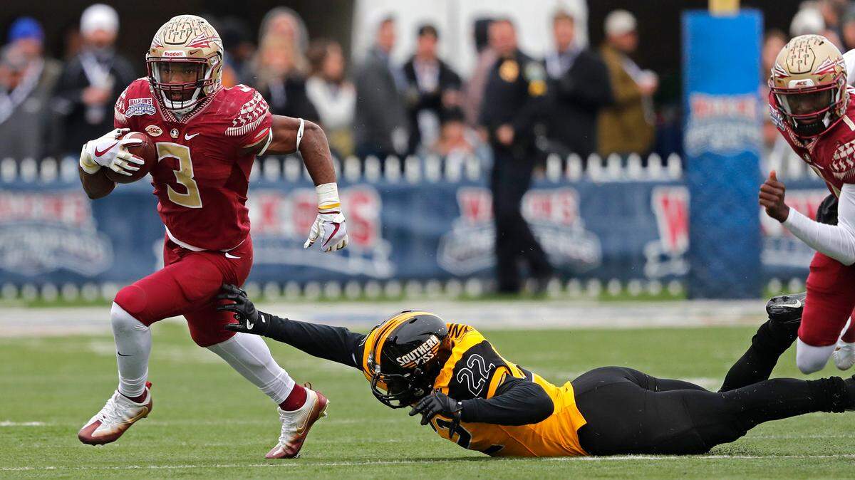 Florida State running back Cam Akers (3) carries past Southern Mississippi linebacker Darian Yancey (22) in the first half of the Independence Bowl NCAA college football game in Shreveport, La., Wednesday, Dec. 27, 2017.