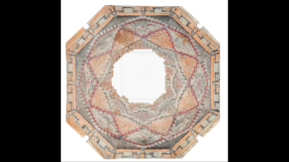 The ceiling, which was partially damaged, is painted with elaborate murals.