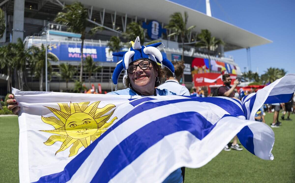 Beatriz Massaferro, holds an Uruguay flag, as she arrives to Hard Rock Stadium before her team's World Cup Group H soccer match against Cape Verde on Sunday, June 21, 2026, in Miami Gardens, Fla.