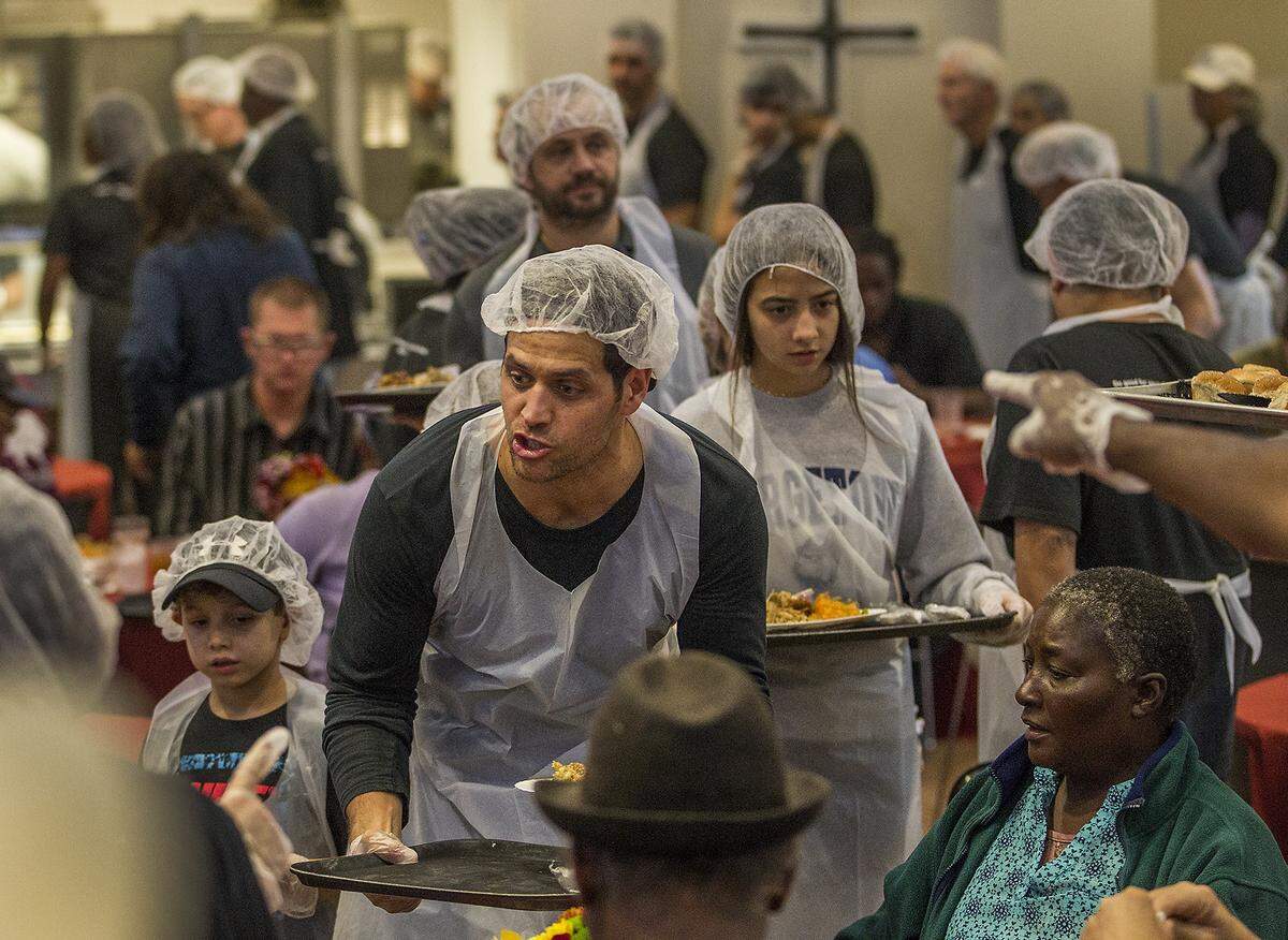 Volunteers serve a gourmet Thanksgiving lunch to more than 300 homeless people at Camillus House  on Thursday November 22, 2018.