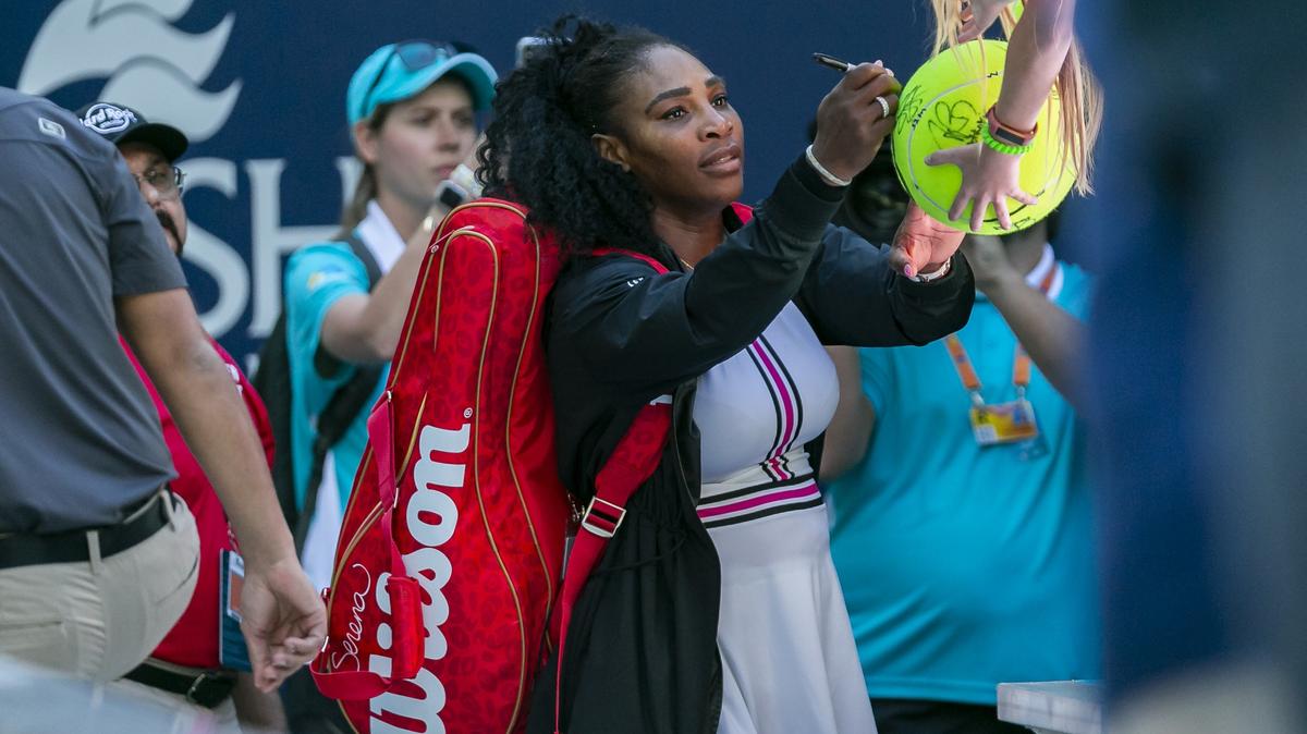 Serena Williams, of the United States, signs a fans tennis ball after defeating Rebecca Peterson, of Sweden, during their match at the Miami Open tennis tournament on Friday, March 22, 2019 at Hard Rock Stadium in Miami Gardens.