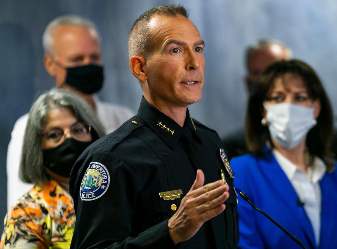 Aventura Police Chief Bryan Pegues speaks during a press conference at the offices of Miami-Dade State Attorney Katherine Fernandez Rundle, far right, in Miami, Florida, on Wednesday, Sept. 8, 2021. Fernandez Rundle announced three arrests made in identity theft cases that targeted victims from the Champlain Towers South condominium collapse.