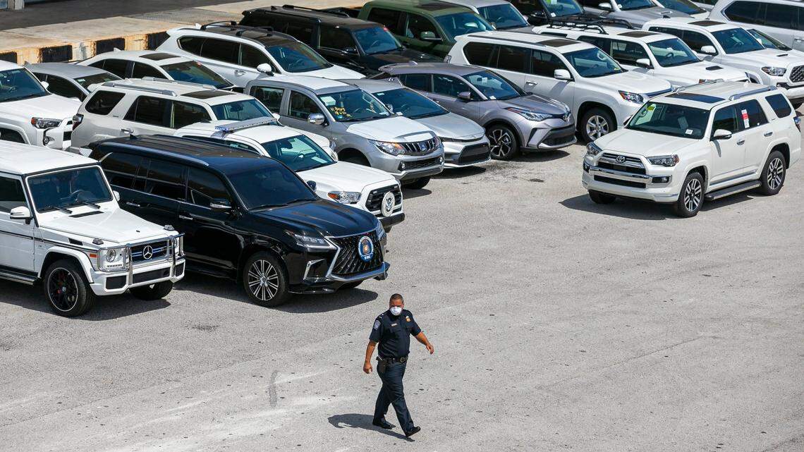 Dylan DeFrancisci, port director for U.S. Customs and Border Protection, walks past more than 80 vehicles seized by Homeland Security Investigations at Port Everglades on Tuesday, July 7, 2020. The vehicles, worth $3.2 million, were being shipped from Port Everglades to Venezuela. The cars, allegedly bought by a ring associated with the government of Venezuelan President Nicolas Maduro, were intercepted by Customs and Border Protection.
