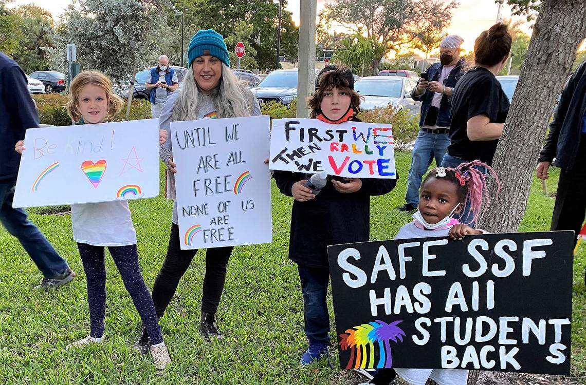 Demonstrators at a Safe Schools South Florida event in Wilton Manors rally against a bill in the state Legislature dubbed “Don’t Say Gay” that would forbid discussions of gender identity and sexuality in public schools. From the left to right, student Juniper Reeves, her mother Holly Reeves, and school friends Benjamin and Amelia Conras. 