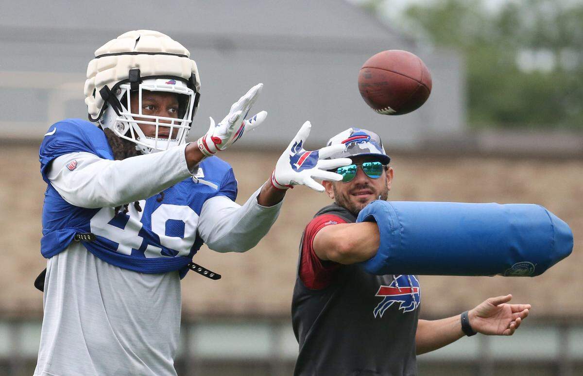 Bills linebacker Tremaine Edmunds (49) eyes in the ball as he is hit by linebackers coach Bobby Babich during interception drills on day nine of Buffalo Bills training camp at St. John Fisher University in Rochester Thursday, Aug. 4, 2022.Sd 080422 Bills Camp 12 Spts