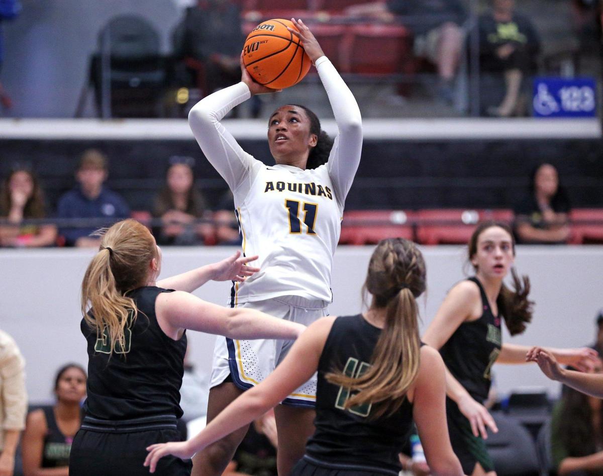 St Thomas Aquinas Jada Green (11) looks to shoot a three-pointer against Nease High School in a girls basketball Class 6A state semifinal at the RP Funding Center in Lakeland on Thursday, February 24, 2022.