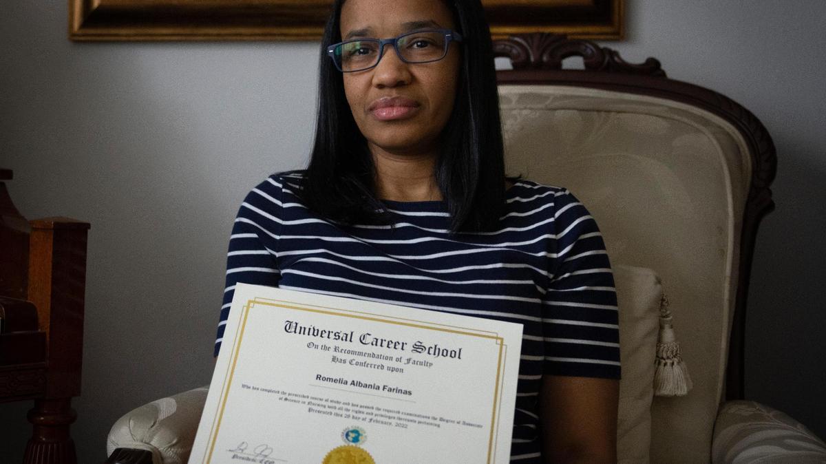 Romelia Farinas with her certificate from Universal Career School, now closed.