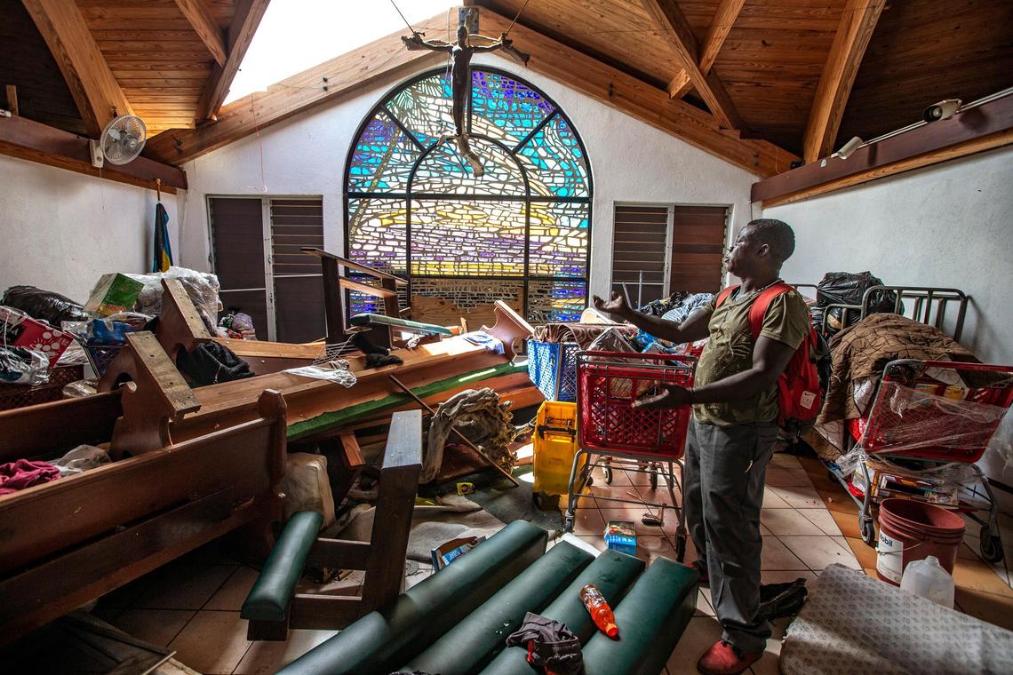 Jean Claude Molien, 47, describes on Sept. 7, 2019, how the wind from Hurricane Dorian pushed the pews towards the altar and punctured a hole in the roof at Saint Francis Catholic Church in Marsh Harbour on Abaco Island.