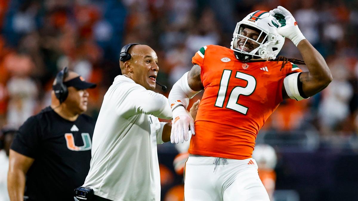 Miami Hurricanes defensive lineman Jahfari Harvey (12) and defensive line coach Jason Taylor react after Harvey sacks Miami of Ohio Redhawks quarterback Brett Gabbert (5) in the first quarter at Hard Rock Stadium in Miami Gardens, Florida on Friday, September 1, 2023.