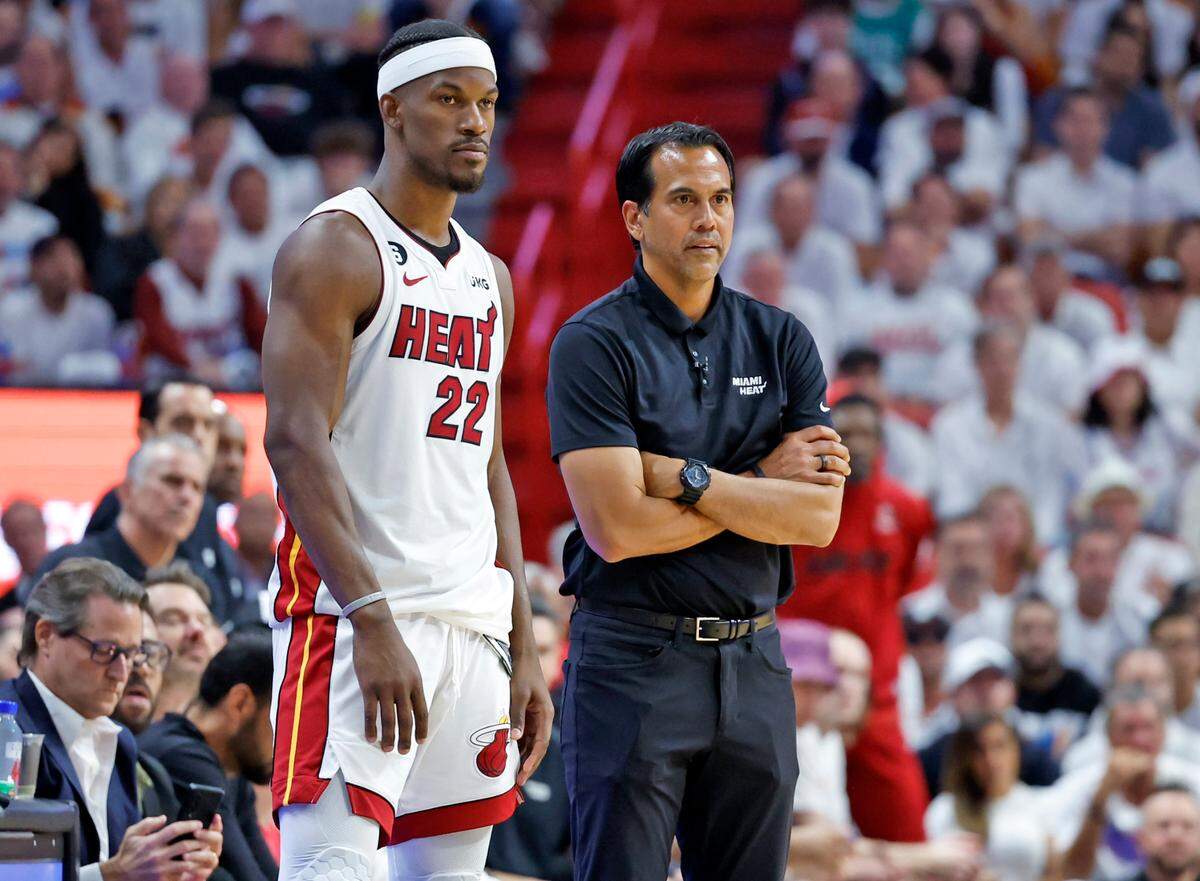 Miami Heat forward Jimmy Butler (22) and coach Erik Spoelstra look across the court during the second quarter in a game against the Boston Celtics in Game 4 of the NBA Eastern Conference Finals at Kaseya Center in Miami on May 23, 2023. 