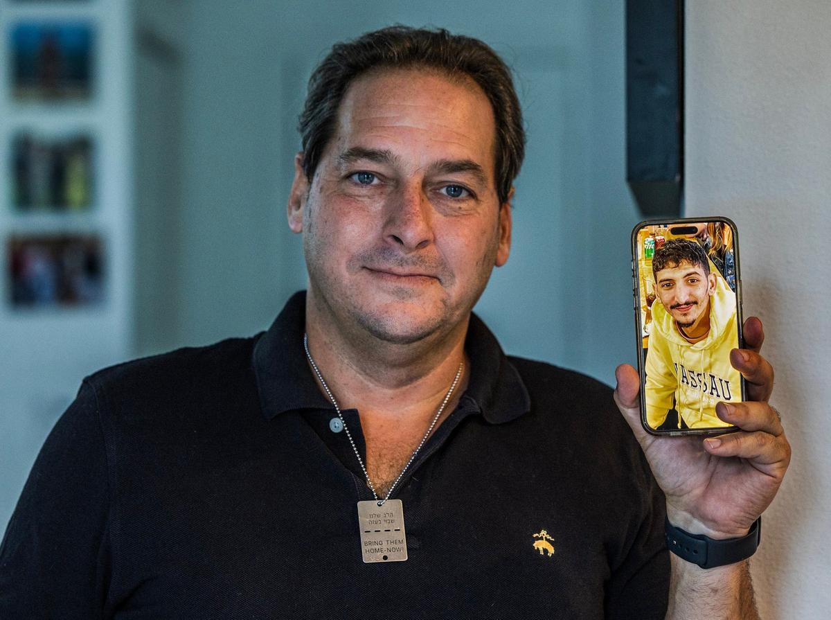 Moises Benaim displays a picture of his nephew Roi Joseph Benaim a survivor of the October 7 Hamas attacks in Israel.