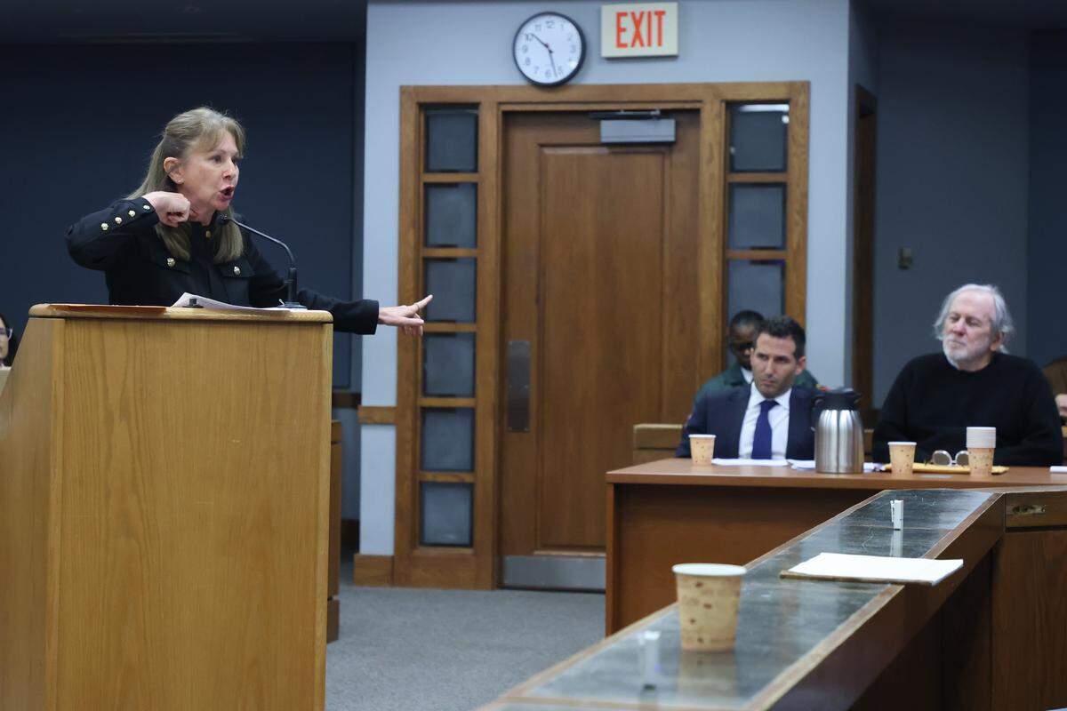 Prosecutor Laura Adams, left, gestures as she recaps the account of the rape and points to Robert Koehler, right, who is standing trial accused of being the “Pillowcase Rapist,” a serial rapist linked to the 1984 cold-case and currently in prison for other sexual assaults in Courtroom 7-3 with Judge David Young presiding on October 28, 2025 at the Richard E. Gerstein Justice Building in Miami, Florida.  Koehler is seated with his attorney Alex Shear, center. 