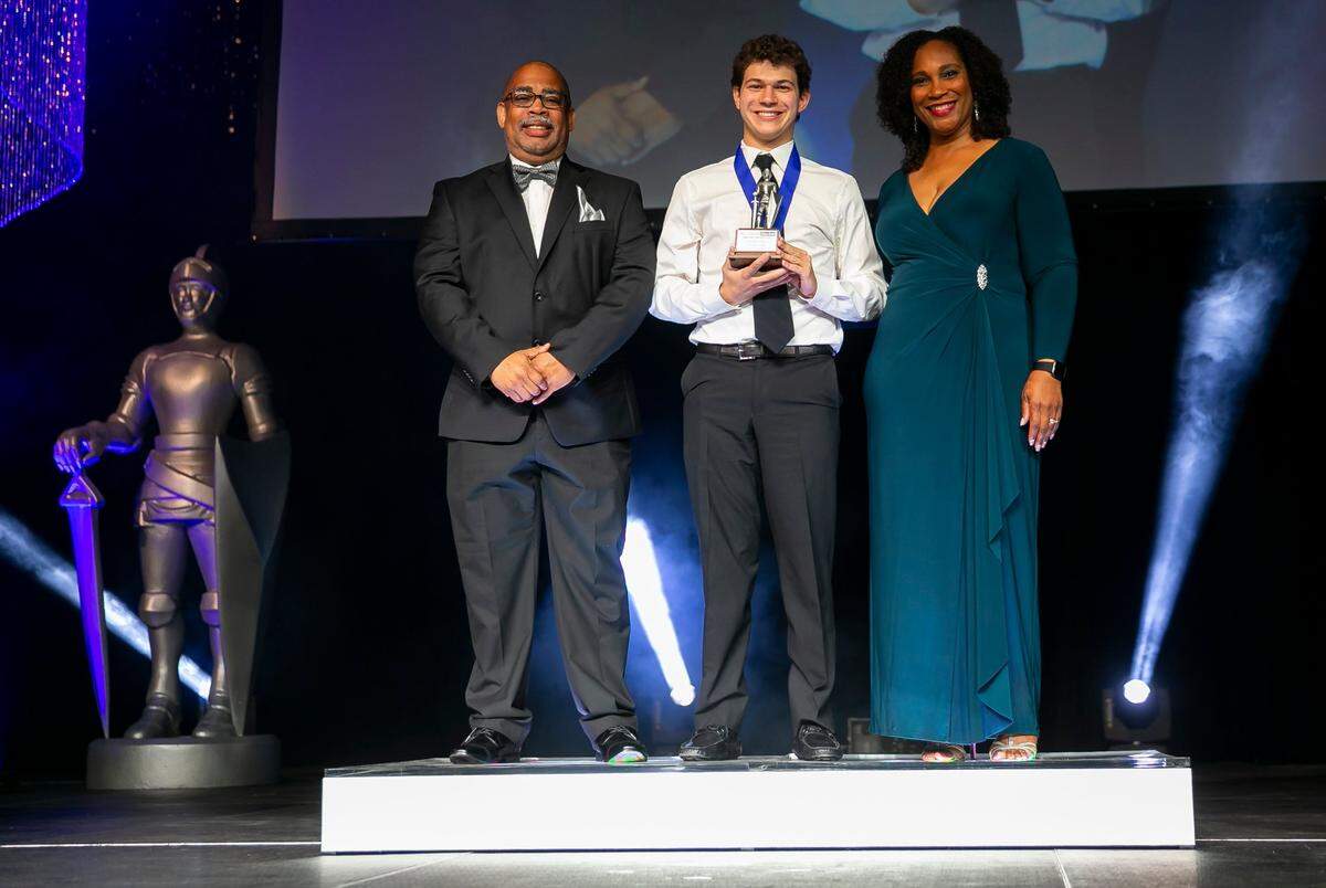 Silver Knight winner in Vocational Technical Tyler Zager, from University School of Nova Southeastern University, is photographed with John Devine, executive sports editor of the Miami Herald, and Natalie Piner -- Vice President, Strategic Business Partner for News -- during the Miami Herald & el Nuevo Herald 64th Silver Knight Awards ceremony at the James L. Knight Center in Miami, Florida on Thursday, May 26, 2022.