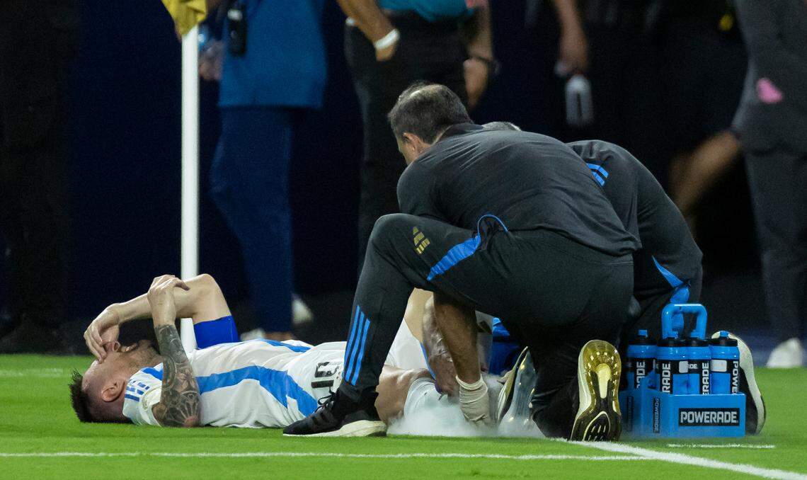 Argentina forward Lionel Messi (10) reacts after hurting his foot on a play against Colombia in the first half of their Copa America 2024 Final soccer match at Hard Rock Stadium on Sunday, July 14, 2024, in Miami Gardens, Fla.