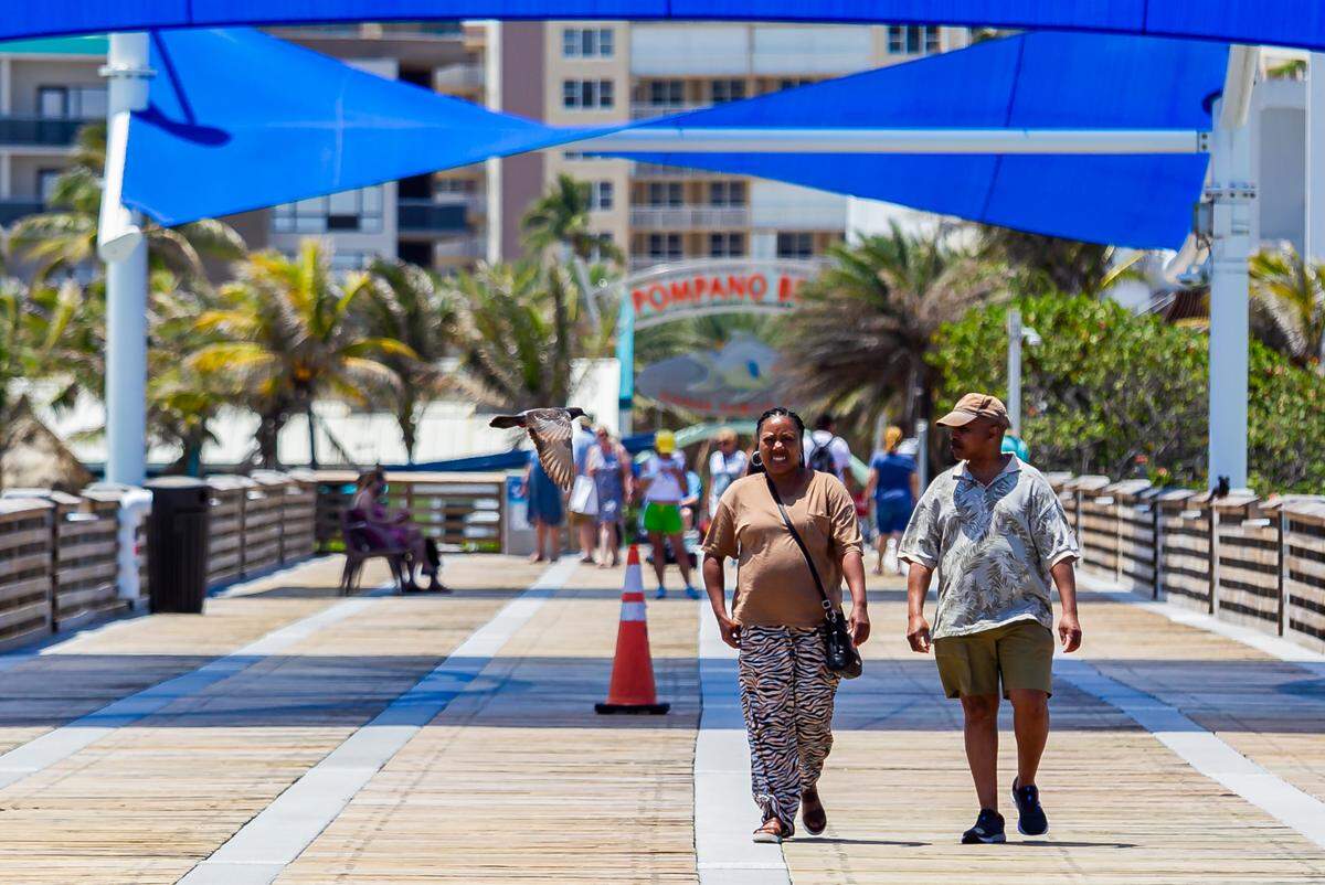 Home sales jumped year-over-year in Broward County. Above: People visit the Pompano Beach Pier in Pompano Beach, Florida on Monday, April 26, 2021.