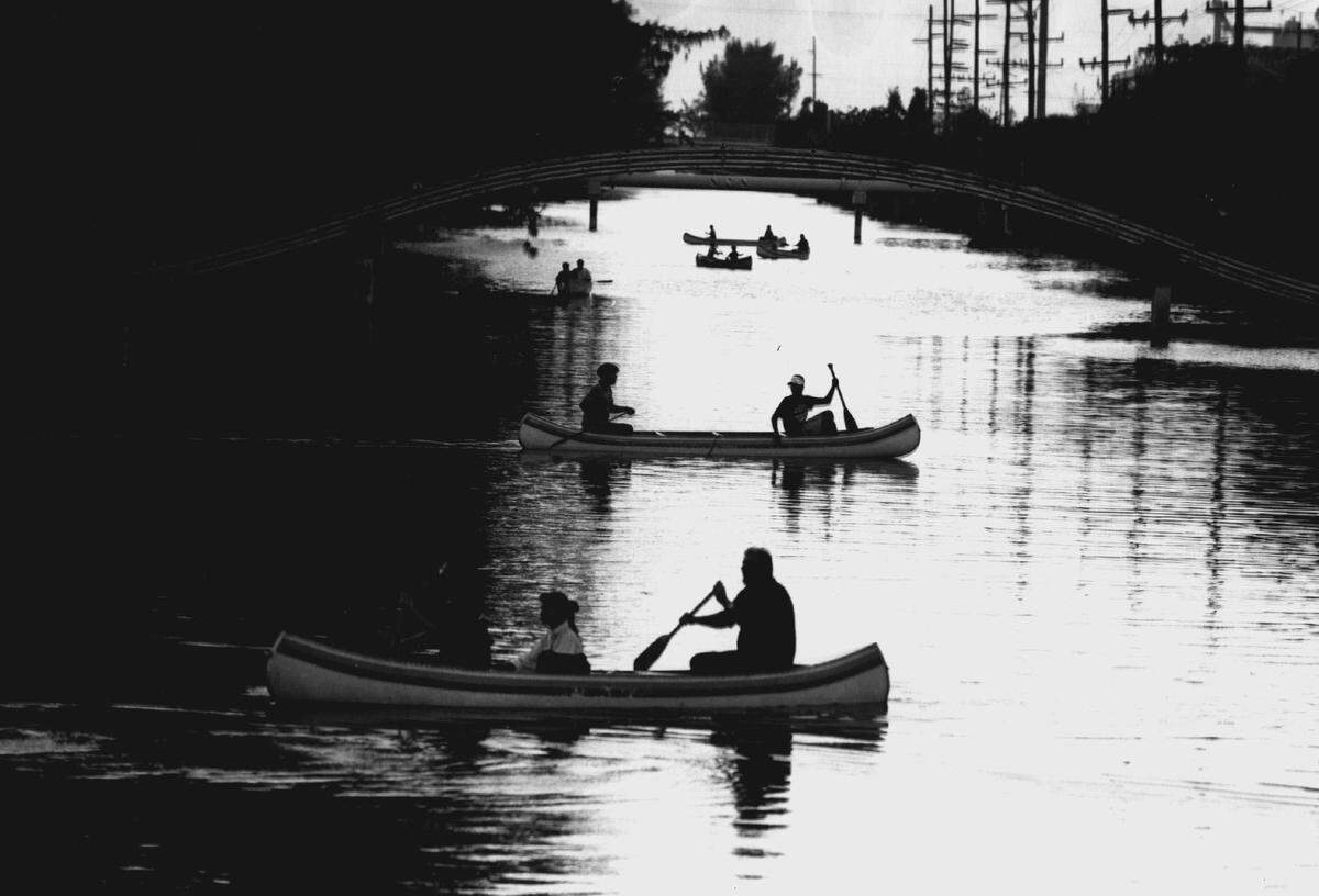 Boaters canoe up the Miami River for a water parade in 1994.