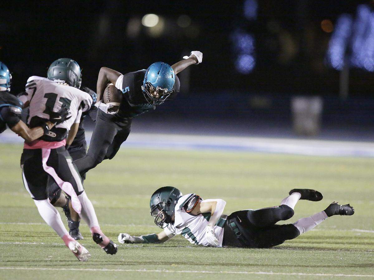 Coral Reef Barracudas running back Amari Germain (5) jumps over Hialeah Gardens Gladiators defender while trying to escape a tackle during football game on Wednesday, November 12, 2025 at Tropical Part in Miami. Andrew Uloza / for Miami Herald