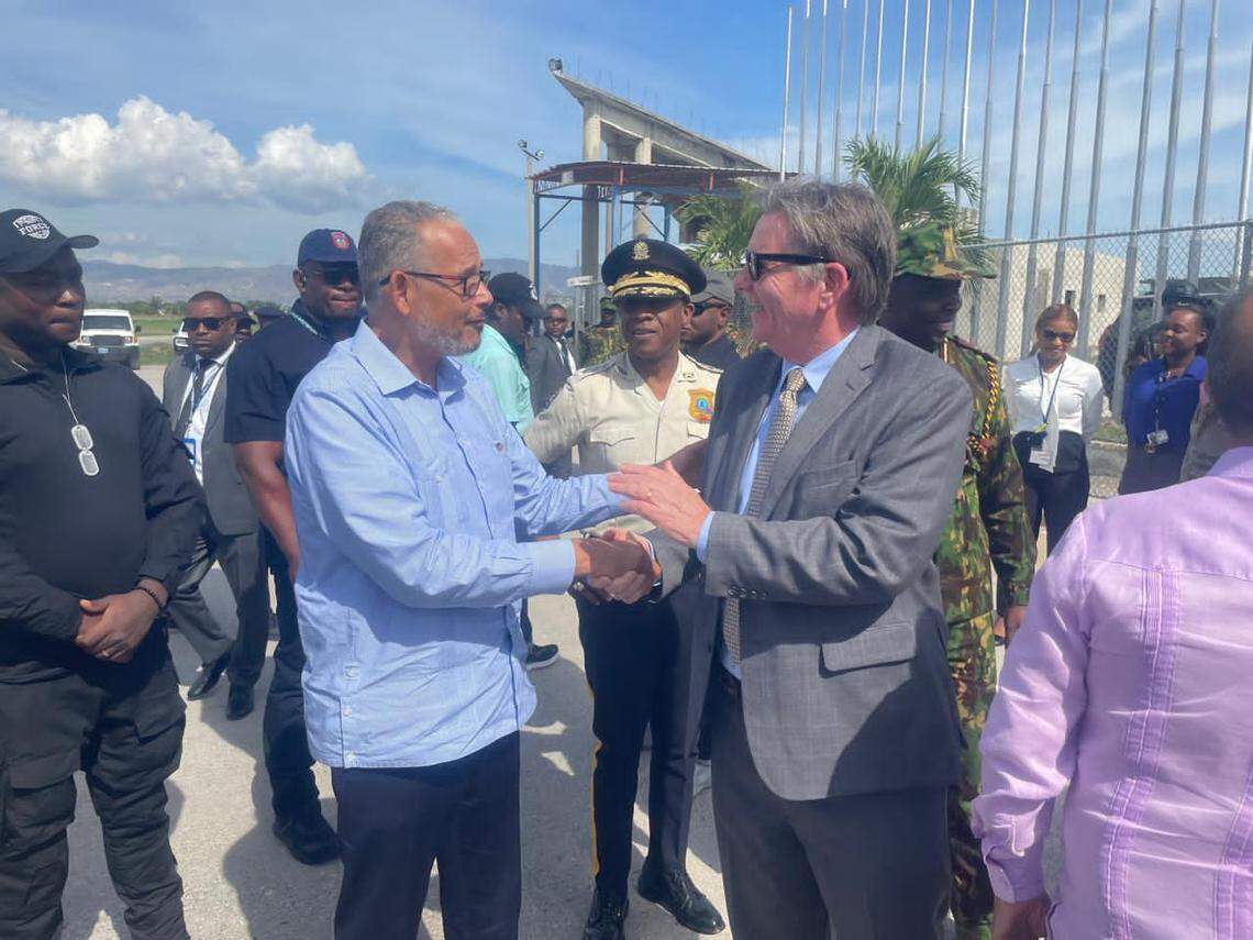 Haiti Prime Minister Alix Didier Fils-Aimé, left, greets U.S. Ambassador Dennis Hankins on Friday, January 3, 2025 at the Toussaint Louverture International Airport in Port-au-Prince after the arrival of more than 75 military police from Guatemala and eight soldiers from El Salvador to join the Kenya-led Multinational Security Support mission in Haiti to fight gangs.