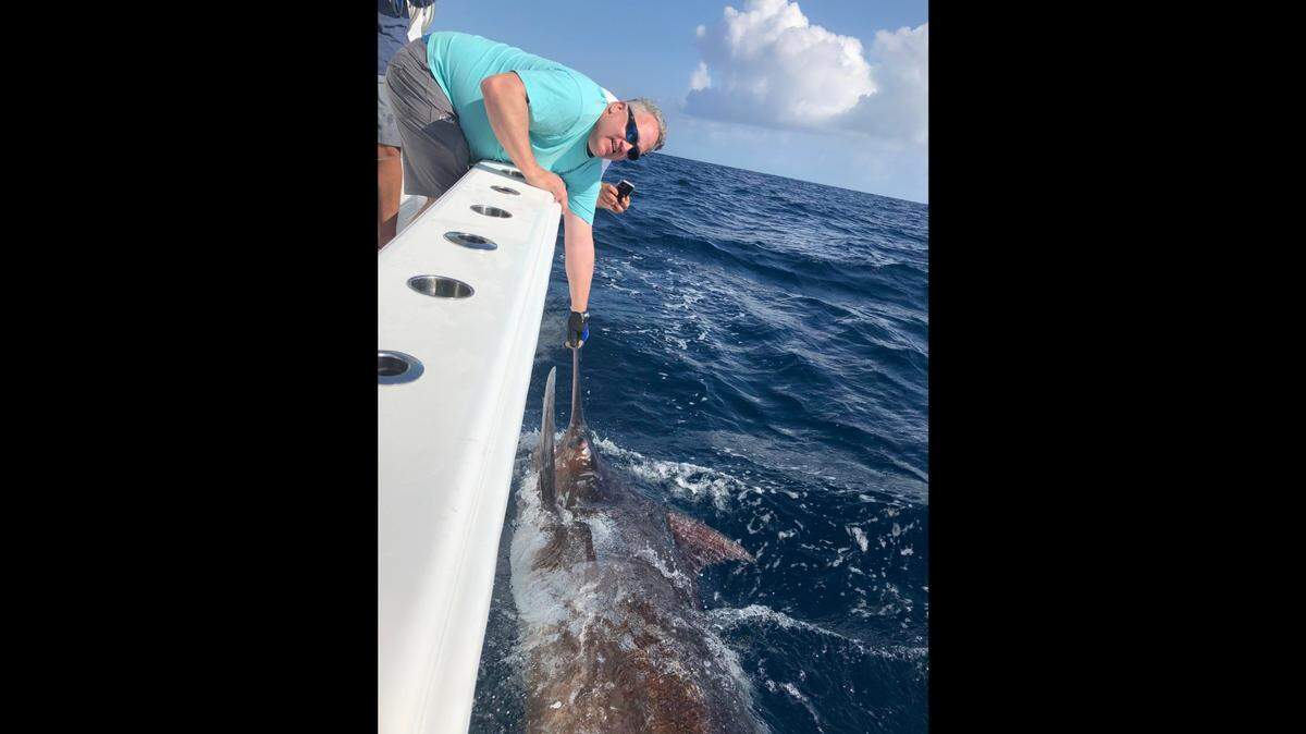 Russ Pilette holds the bill of a 450-pound blue marlin caught off Marathon in the Florida Keys, Saturday, Feb. 13, 2021.