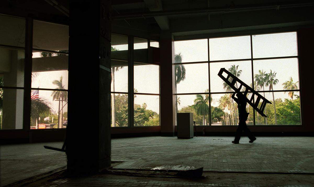 Construction workers in the former Omni mall’s ‘food court, under conversion to the Omni Technology Center. The former mall offered a million square feet to high-tech vendors.