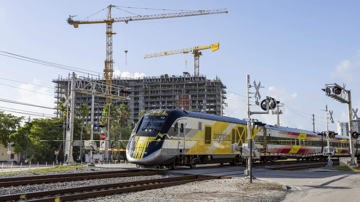 A Brightline train crosses through Northeast 141st Street near Biscayne Boulevard in April 2025.