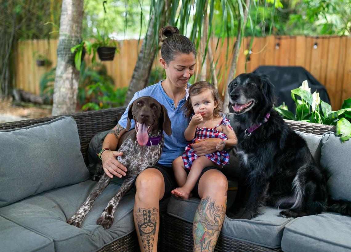 Broward Sheriff’s Office Battalion Chief Nichole Notte, 41, her daughter, Luca, 1, and her two dogs, Dig, right, and Ember, are photographed at their home on Tuesday, June 21, 2022, in Fort Lauderdale, Fla.