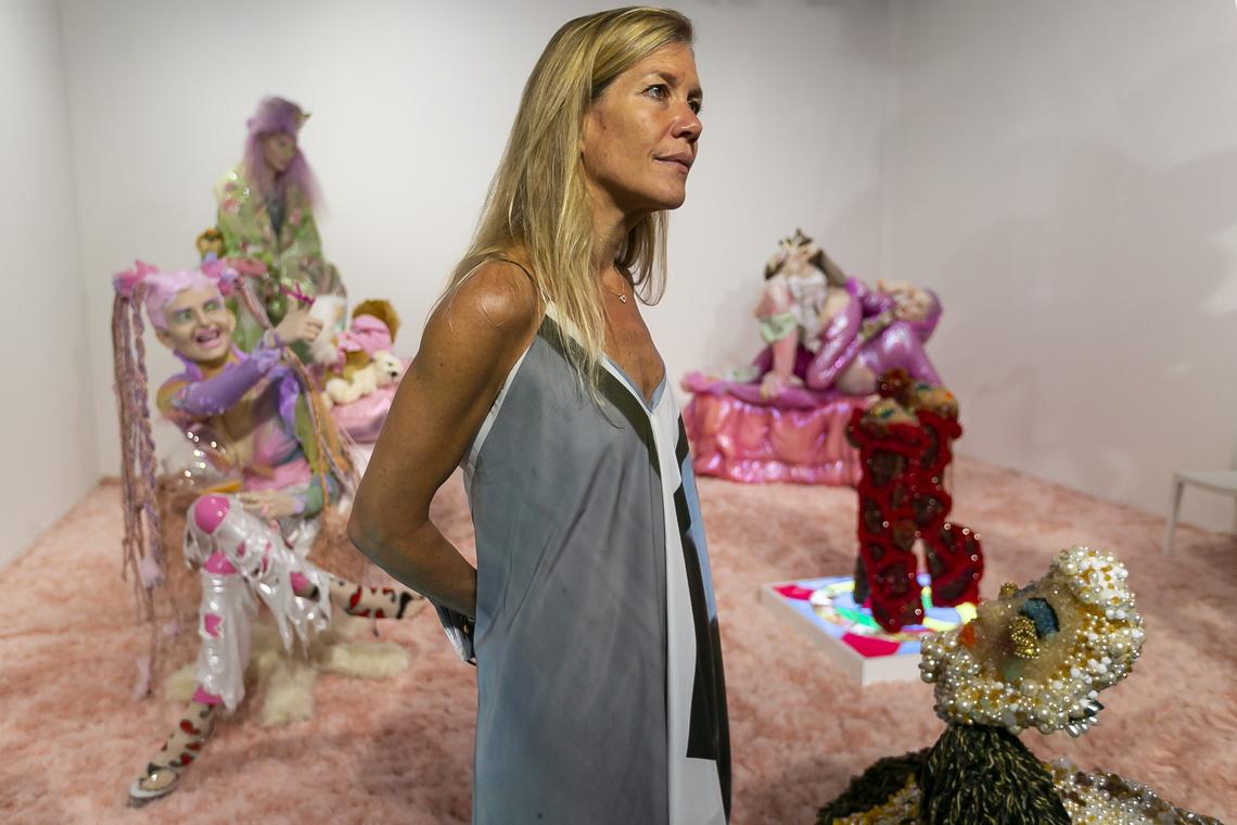 Kathryn Mikesell, co-founder and director of the Fountainhead Residency for artists in Miami, looks at sculptures in an installation by program alum Raul de Nieves and Cajsa von Zeipel during the Art Basel fair VIP opening at the Miami Beach Convention Center.