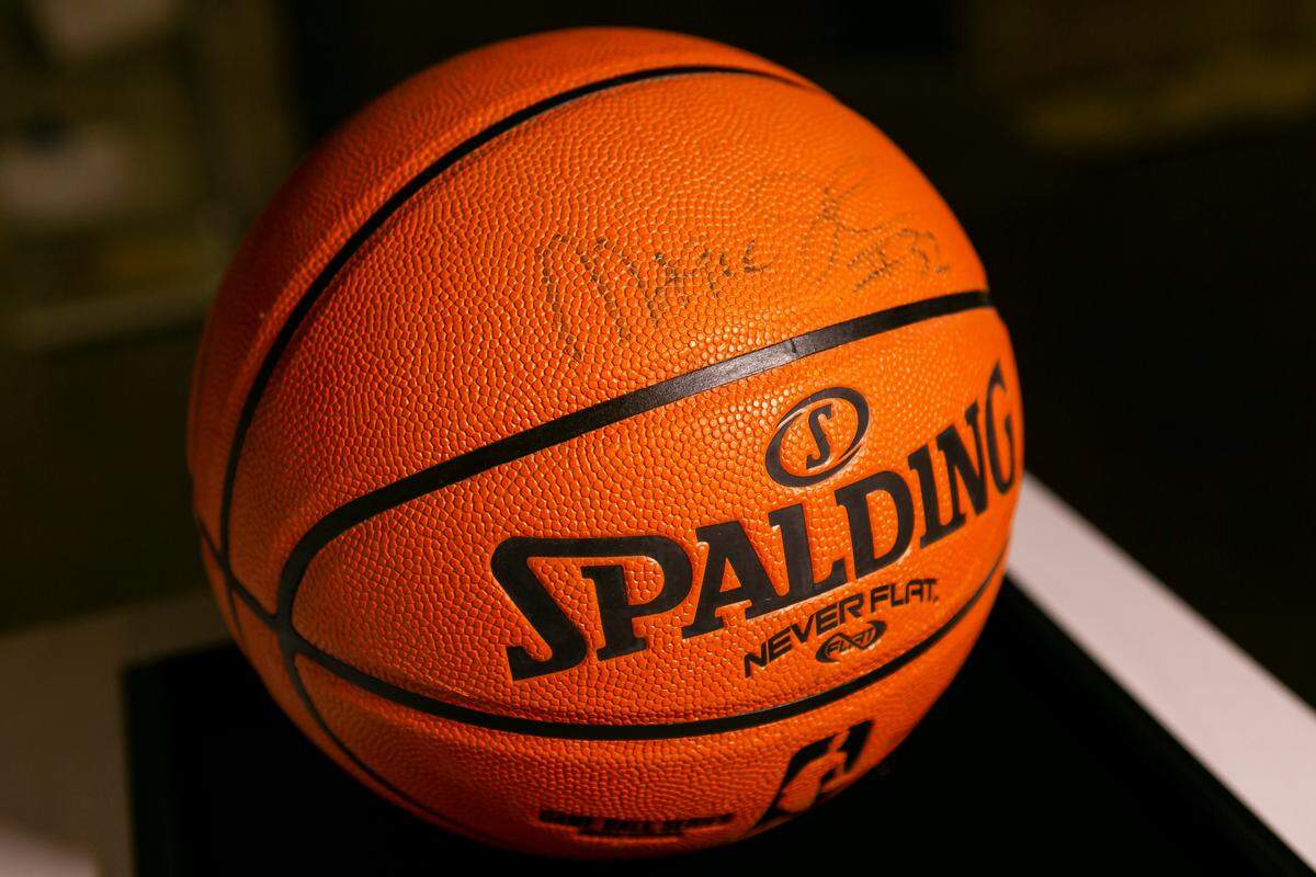 A basketball signed by former NBA player Magic Johnson is on display as part of the exhibit, A Matter of Time: Examining Forty Years of AIDS While Living through a Pandemic, at the Coral Gables Museum in Miami, Florida on Monday, April 5, 2021.
