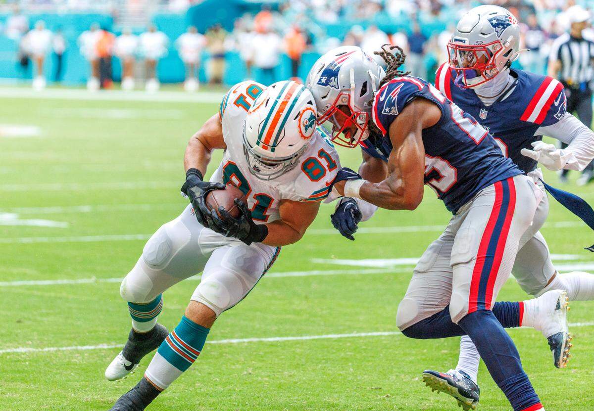Miami Dolphins tight end Durham Smythe (81) runs as New England Patriots safety Kyle Dugger (23) defends reacts after a play during third quarter of an NFL football game against the New England Patriots at Hard Rock Stadium on Sunday, Oct. 29, 2023 in Miami Gardens, Fl.