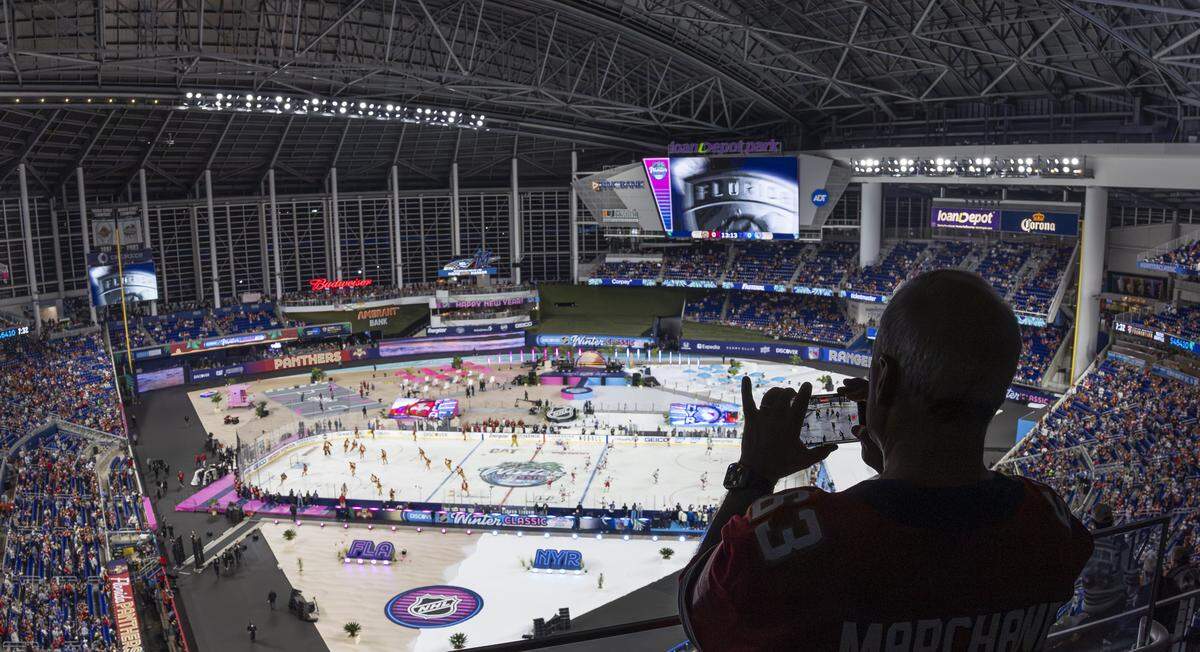 A Florida Panthers fan watches his team warm up before they play against the New York Rangers in their Winter Classic outdoor hockey game at loanDepot park on Friday, Jan. 2, 2025, in Miami, Fla.