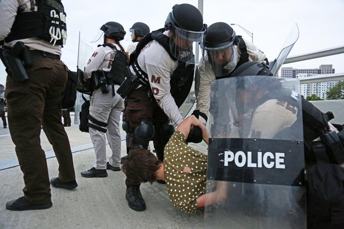 A woman demonstrator gets arrested by Miami police officers after police declared an unlawful assembly on SW 8th Street and 107th Avenue, in Miami, Florida, Saturday, June 6, 2020.