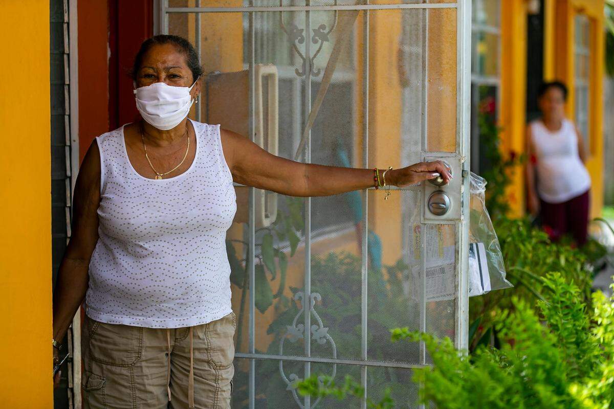 Dolores Arozarena, 72, stands outside of her home after County Commissioner Eileen Higgins gave her free face masks and COVID-19 informational packets in Little Havana, Florida on Saturday, June 27, 2020. Higgins deployed the team near Little Havana residents who live in coronavirus hotspots.