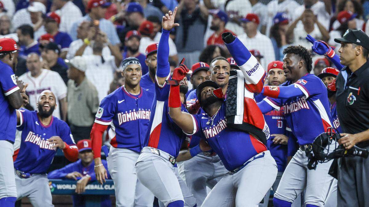 Dominican Republic first baseman Vladimir Guerrero Jr. (27), seen at center, celebrates with teammates at homeplate after hitting a homerun in the third inning against Venezuela during the World Baseball Classic at loanDept park on Wednesday, March 11, 2026. 