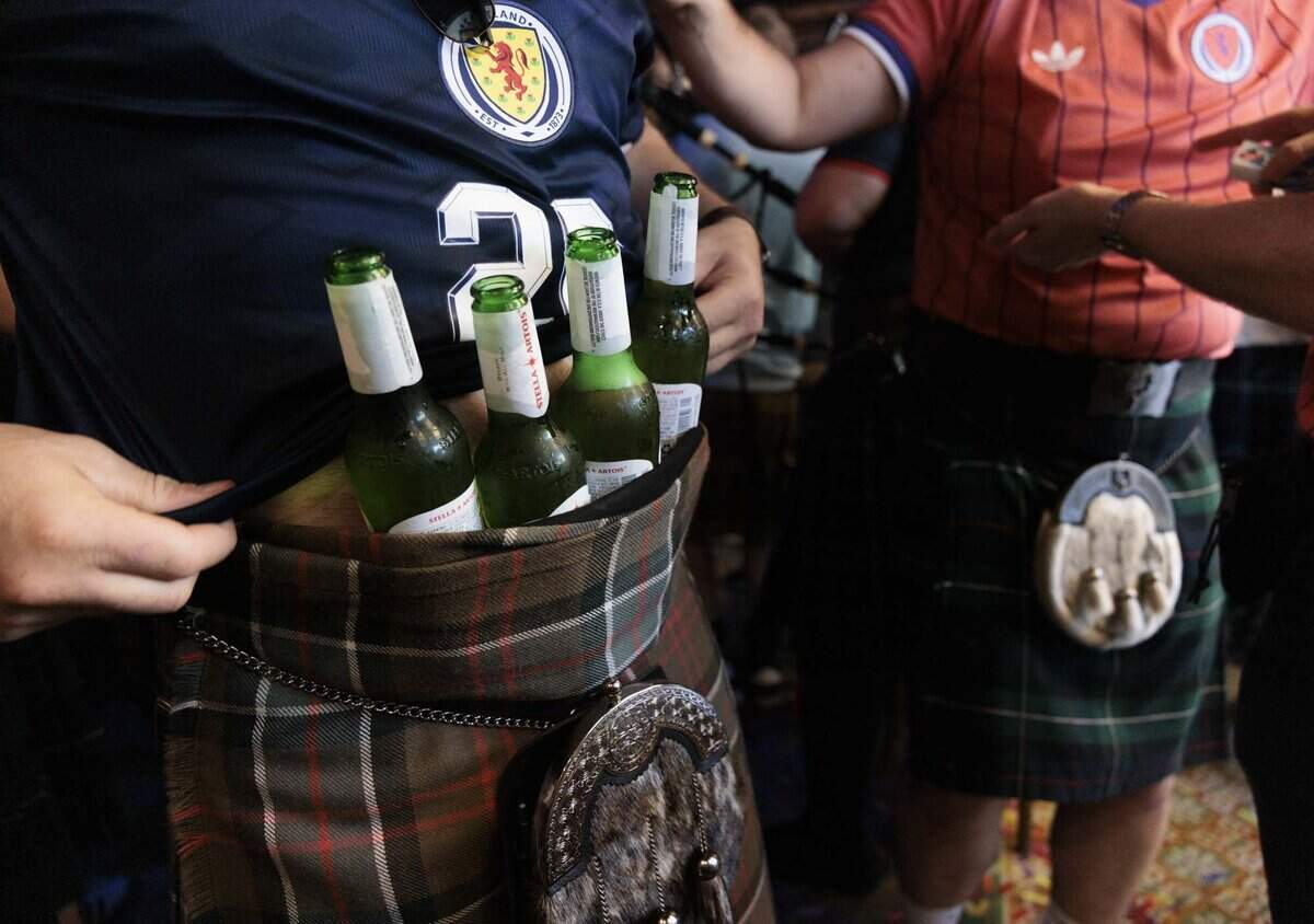 Charlie Sinclair, from Scotland, holds cold beer in his kilt during a gathering of Tartan Army, Scottish National Football team fans, at Ball & Chain on Monday, June 22, 2026, before a parade down Calle Ocho in Miami, Fla.