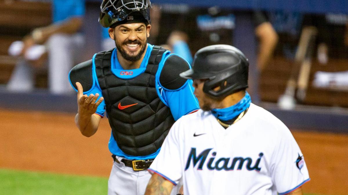 Marlins catcher Jorge Alfaro laughs with outfielder Harold Ramirez after his at bat during a simulation game at Marlins Park in Miami, Florida on Friday, July 10, 2020.
