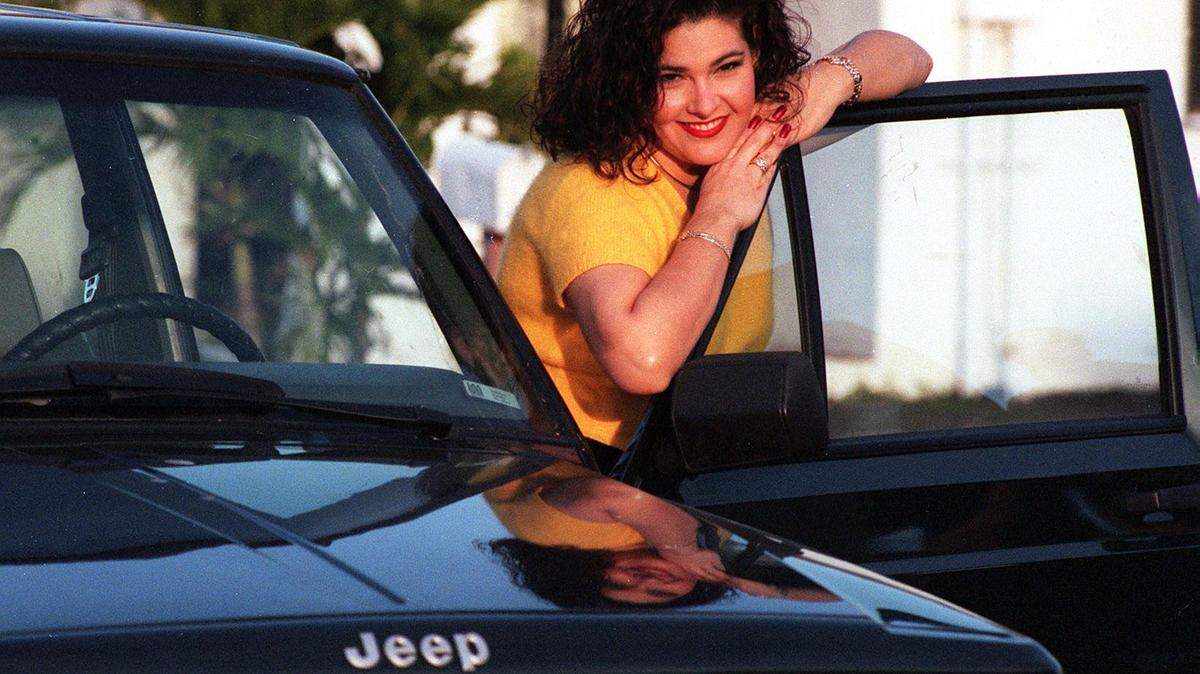 In 1997, Ana Margarita Martinez poses with the 1994 Jeep Cherokee that Juan Pablo Roque says is the one thing he misses about Miami. She sold the vehicle to a family friend.