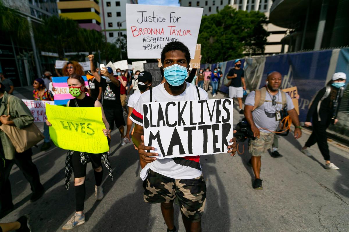 Activists make their way toward Overtown during a Justice for George Floyd protest in downtown Miami on Monday, June 1, 2020.