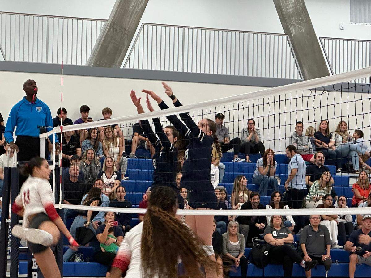 Gulliver sophomore Kate Welty (left) and freshman Gabby De haan (right) set up to block Cardinal Gibbons junior Beatriz Matos during Tuesday’s Region 4-3A quarterfinal volleyball match at the Gulliver Prep gym in Miami, Fla.