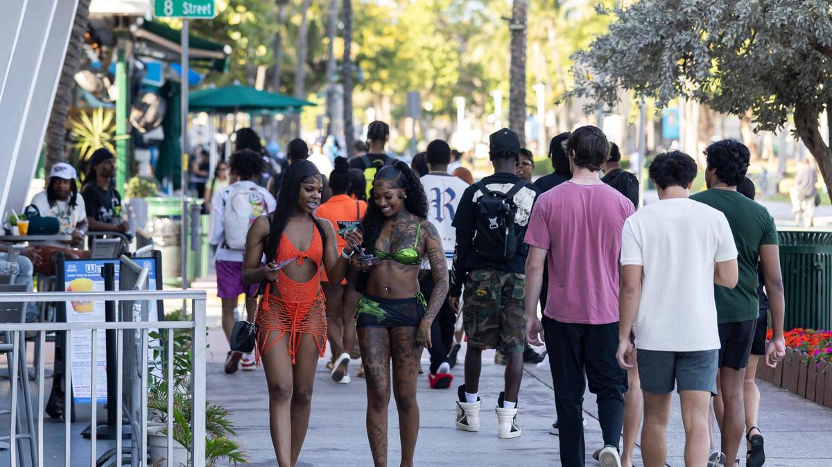 People make their way down Ocean Drive during spring break on Friday, March 14, 2025, in Miami Beach, Fla.