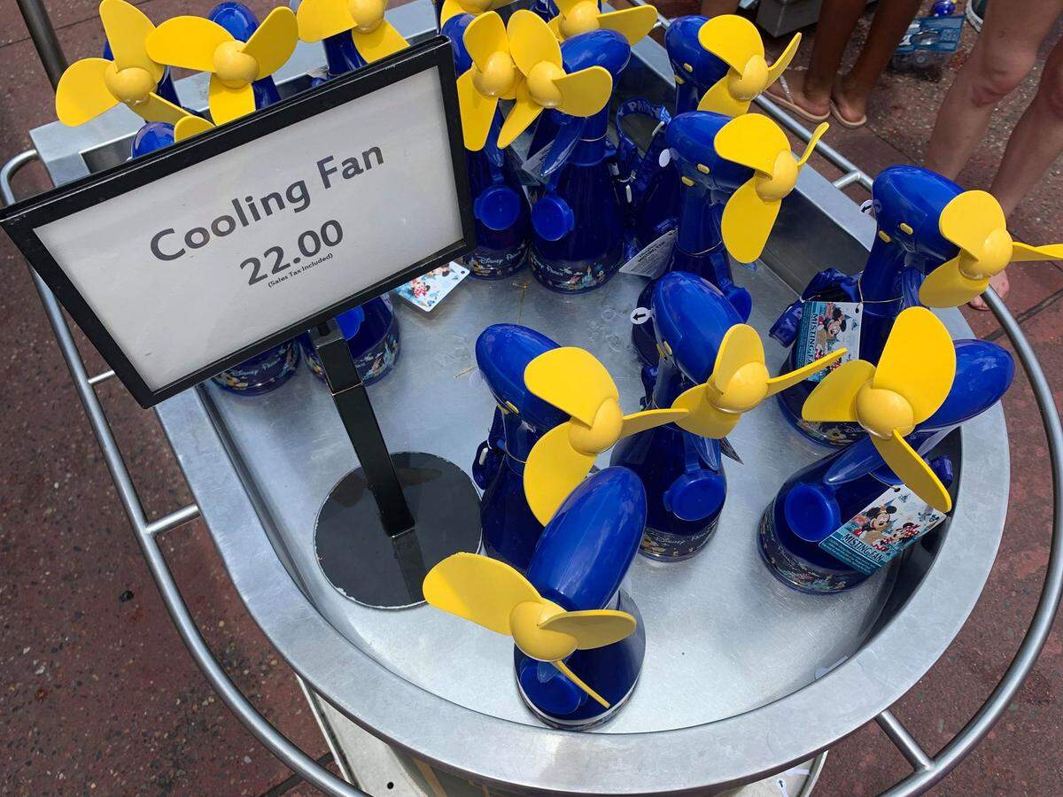 Misting fans at $22 a pop are a popular item in the Disney gift shops in Orlando as temperatures soar into the 90s with heat indexes busting past triple digits at the Florida tourist attraction.