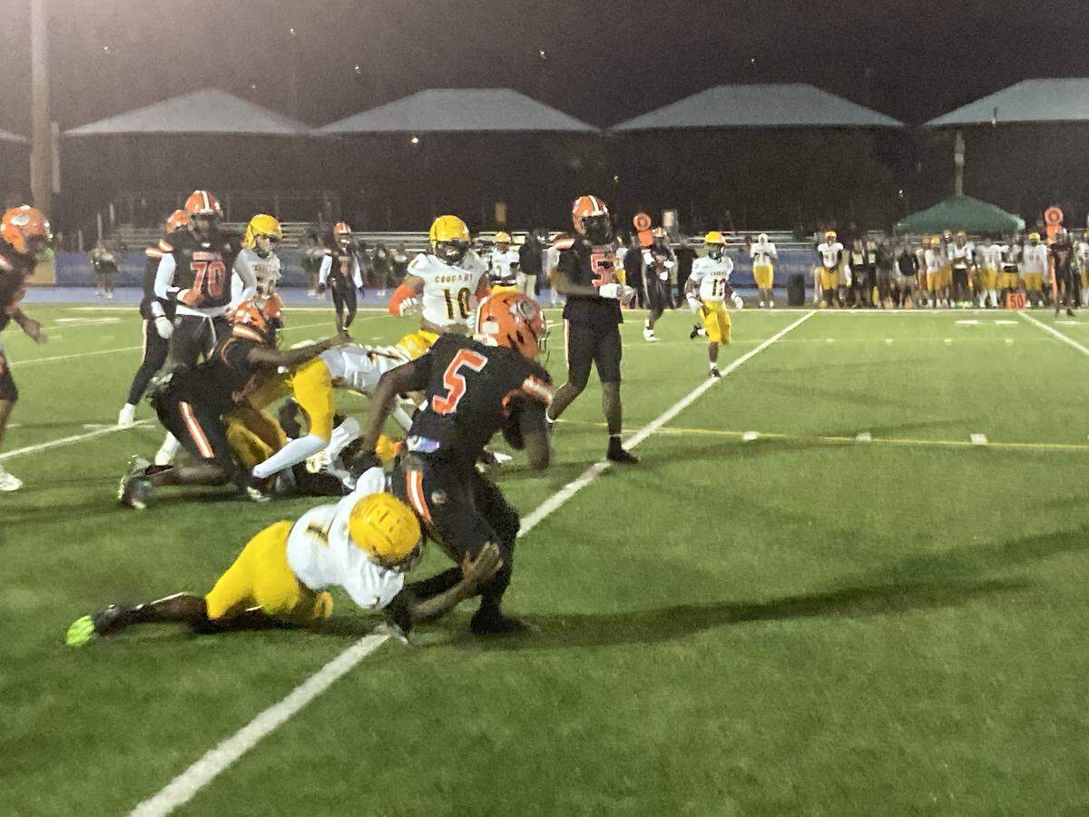 Killian defensive back Artrell Vance brings down Carol City running back Justin Compere after a short gain during Friday’s Region 4-2A quarterfinal at Betty Ferguson Park in Miami Gardens, Fla.