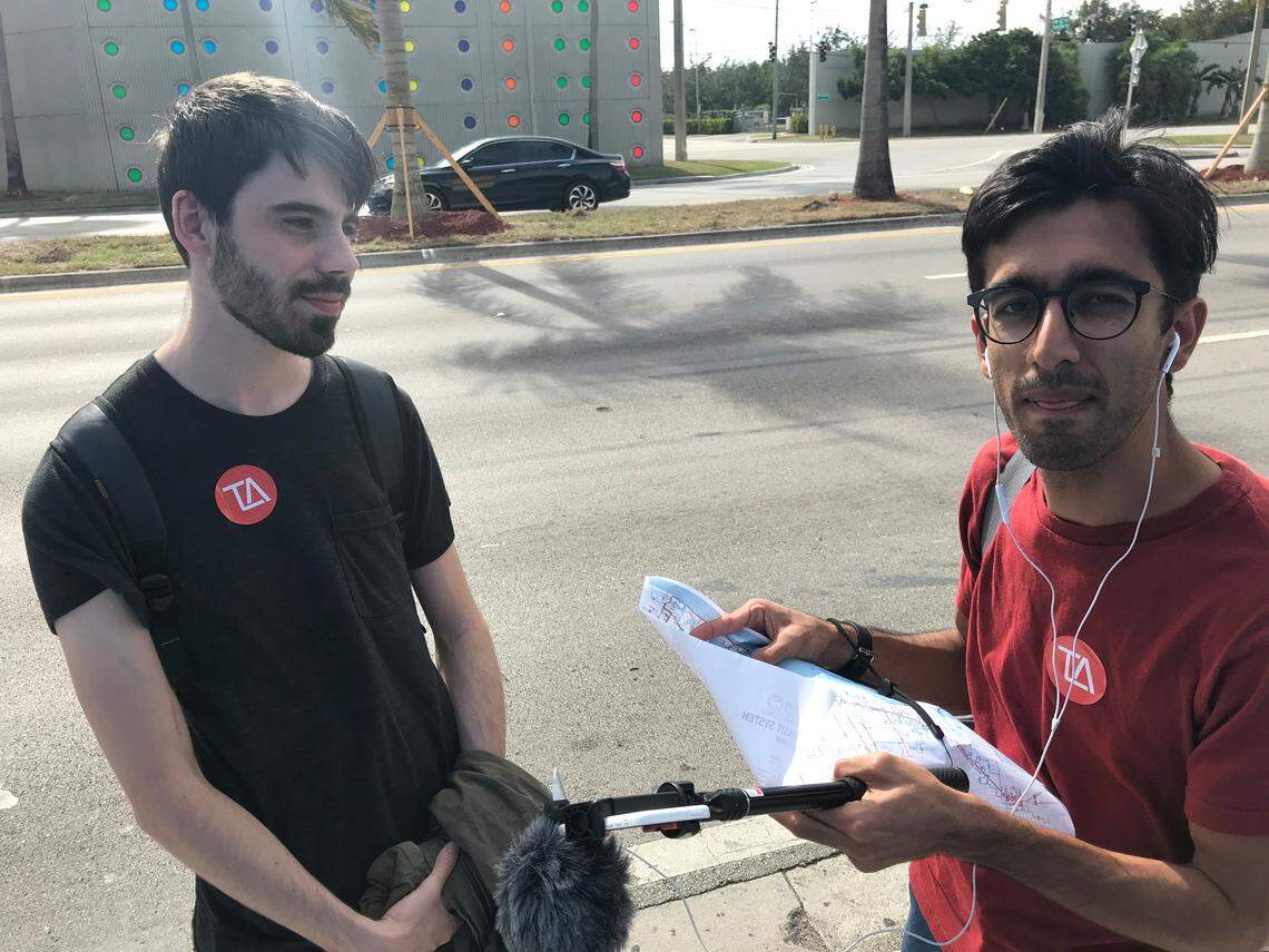 Richard Hankins, left, and Azhar Chougle plot their next move on 36th Street in Virginia Gardens after just missing the 36 bus they wanted to take to the Dolphin Mall during a planned 24-hour marathon of Miami-Dade bus rides on Friday, Dec. 14, 2018. The next bus wasn’t scheduled to arrive for an hour.