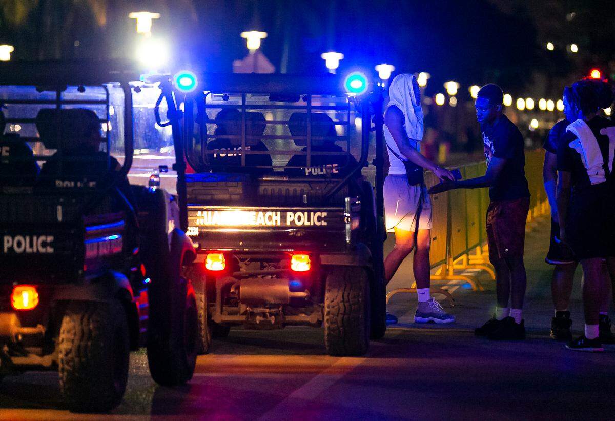 Police officers patrol down Ocean Drive in Miami Beach, Florida on Friday, March 25, 2022. City officials imposed a midnight curfew and forced stores to stop selling alcohol after 6 p.m. The restrictions were set in place after two shootings in Miami Beach the weekend before caused city officials to announce a “state of emergency.”