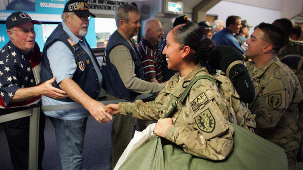 Veterans welcome home newly arrived troops from conflict abroad.